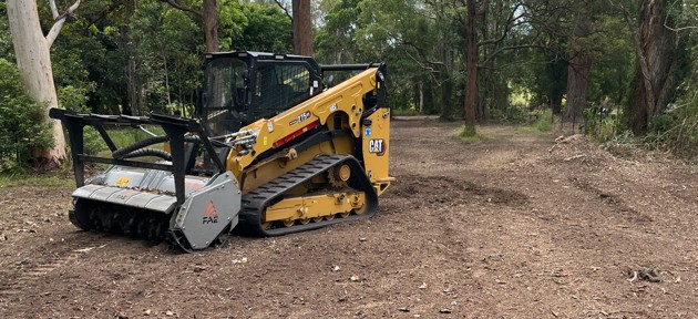 CAT skid steer with FAE forestry mulcher head on cleared bushland — Somerset region