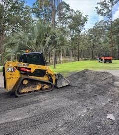 CAT skid steer pushing and levelling soil on acreage — Sunshine Coast